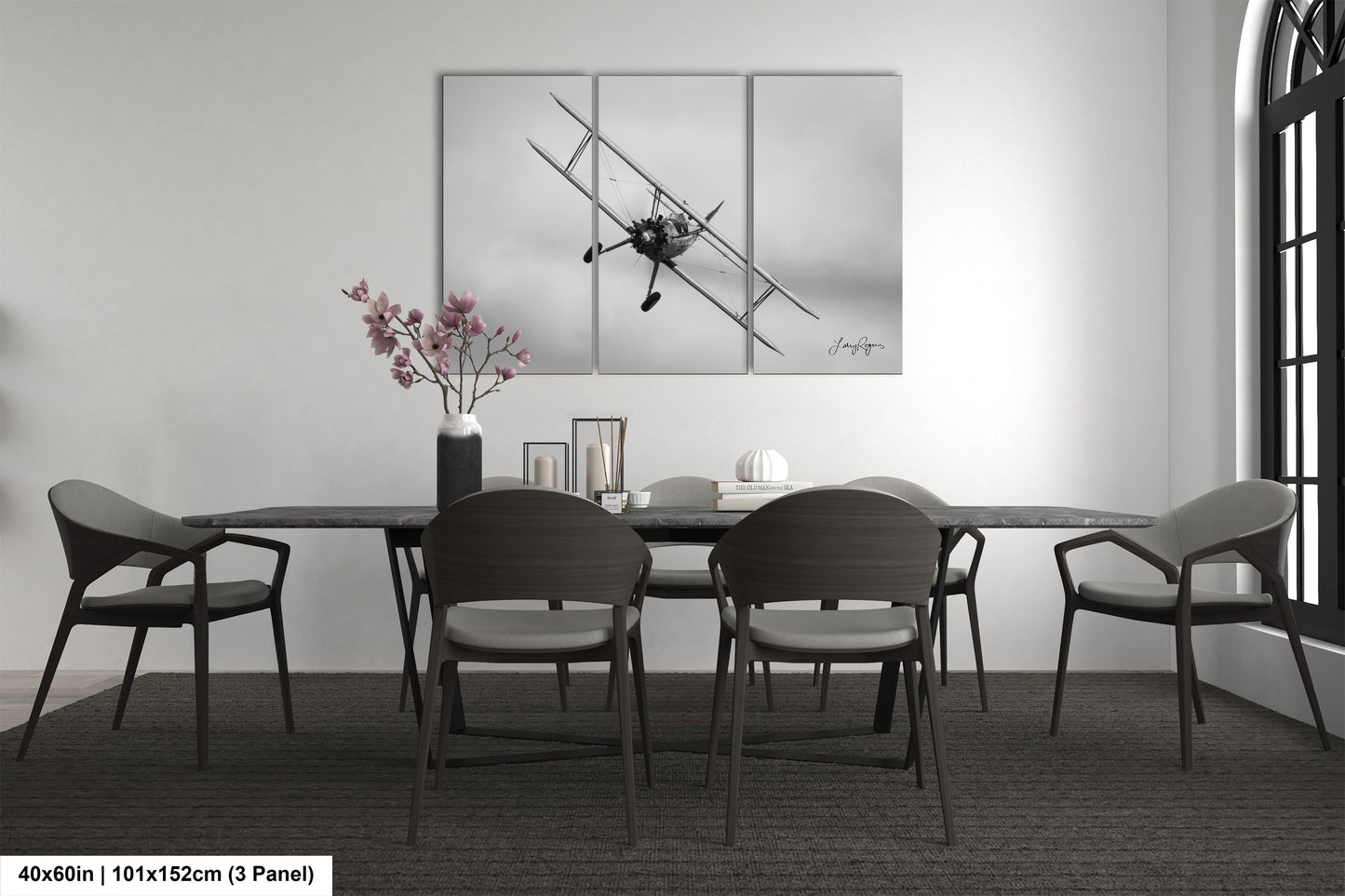 a dining table with four chairs and a vase of flowers