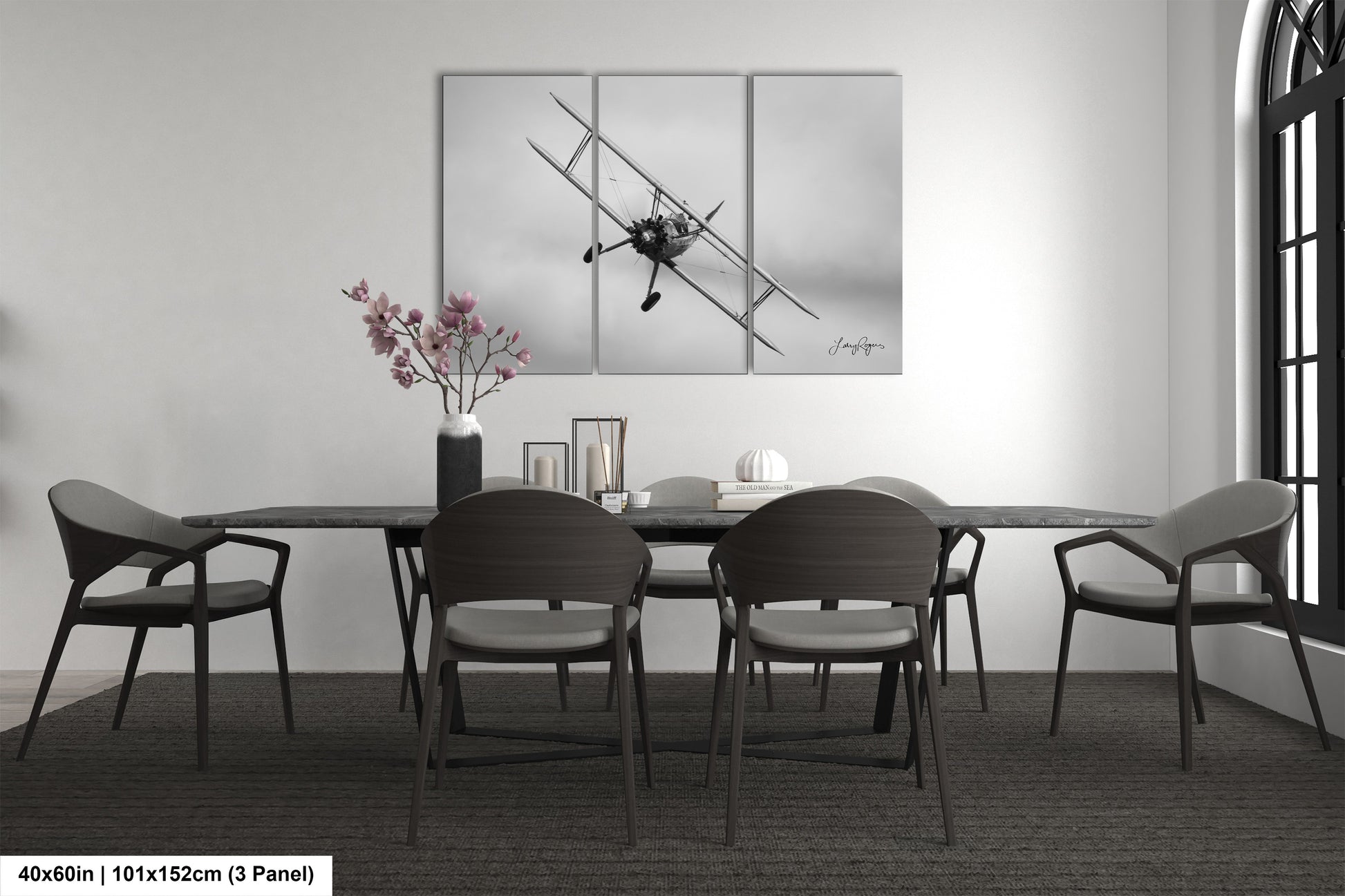 a dining table with four chairs and a vase of flowers