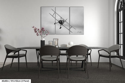 a dining table with four chairs and a vase of flowers