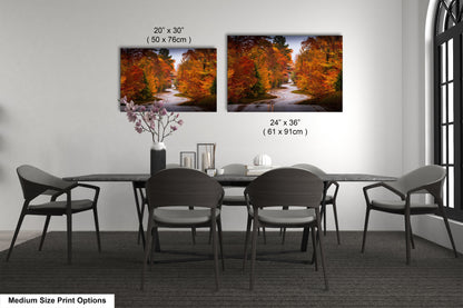 a dining table with four chairs and a vase of flowers