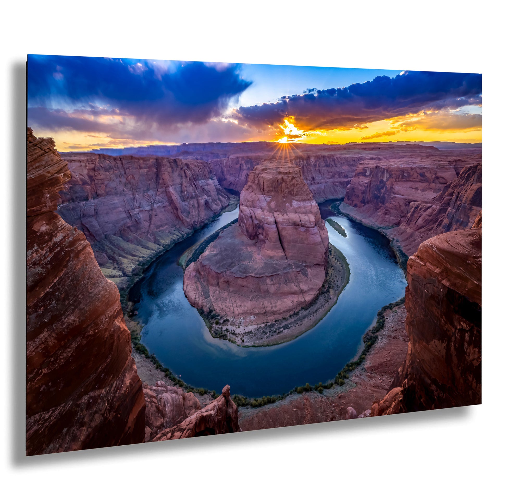 the sun is setting over a river in a canyon