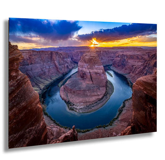 the sun is setting over a river in a canyon