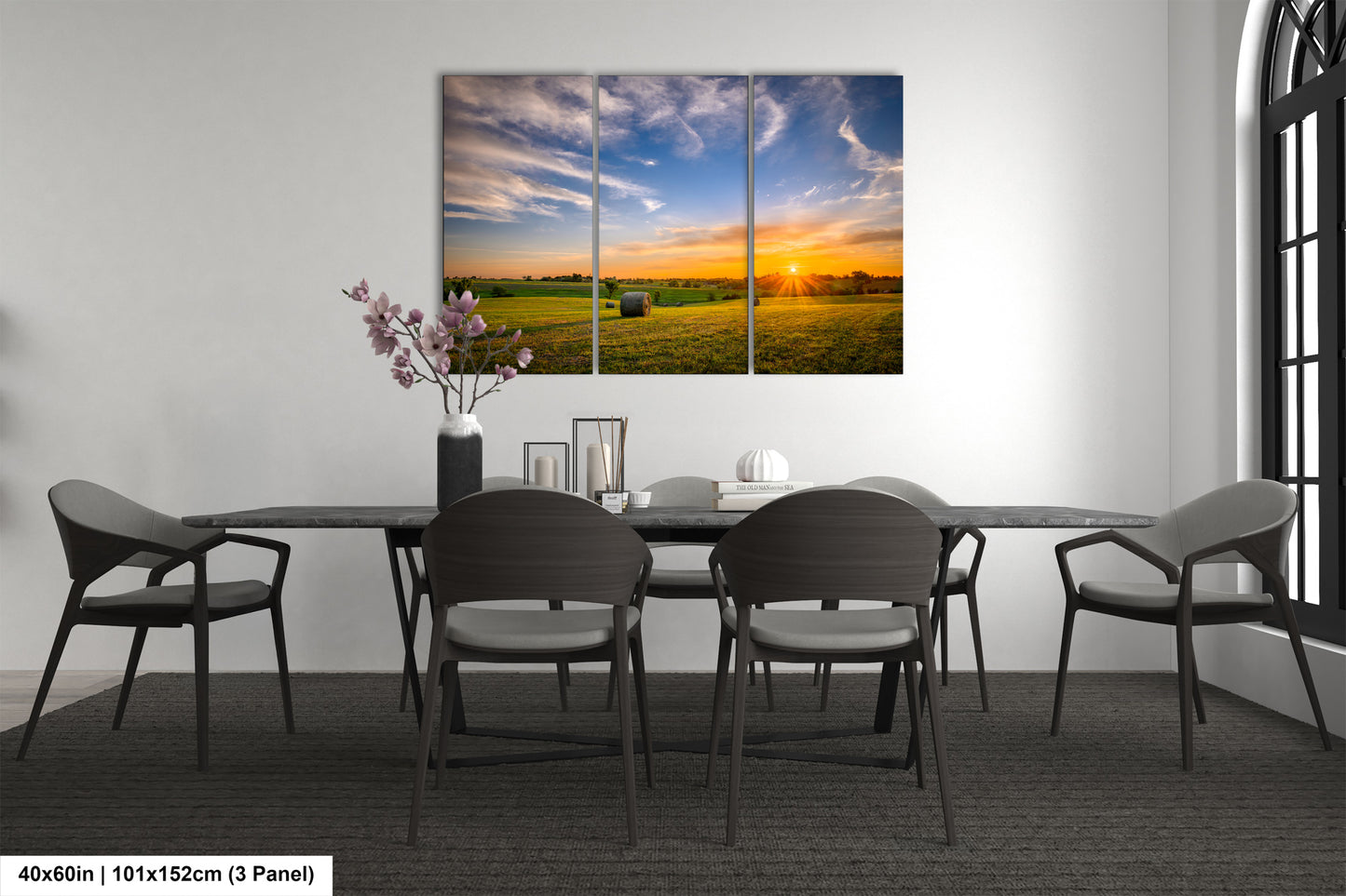 a dining room table with chairs and a painting on the wall