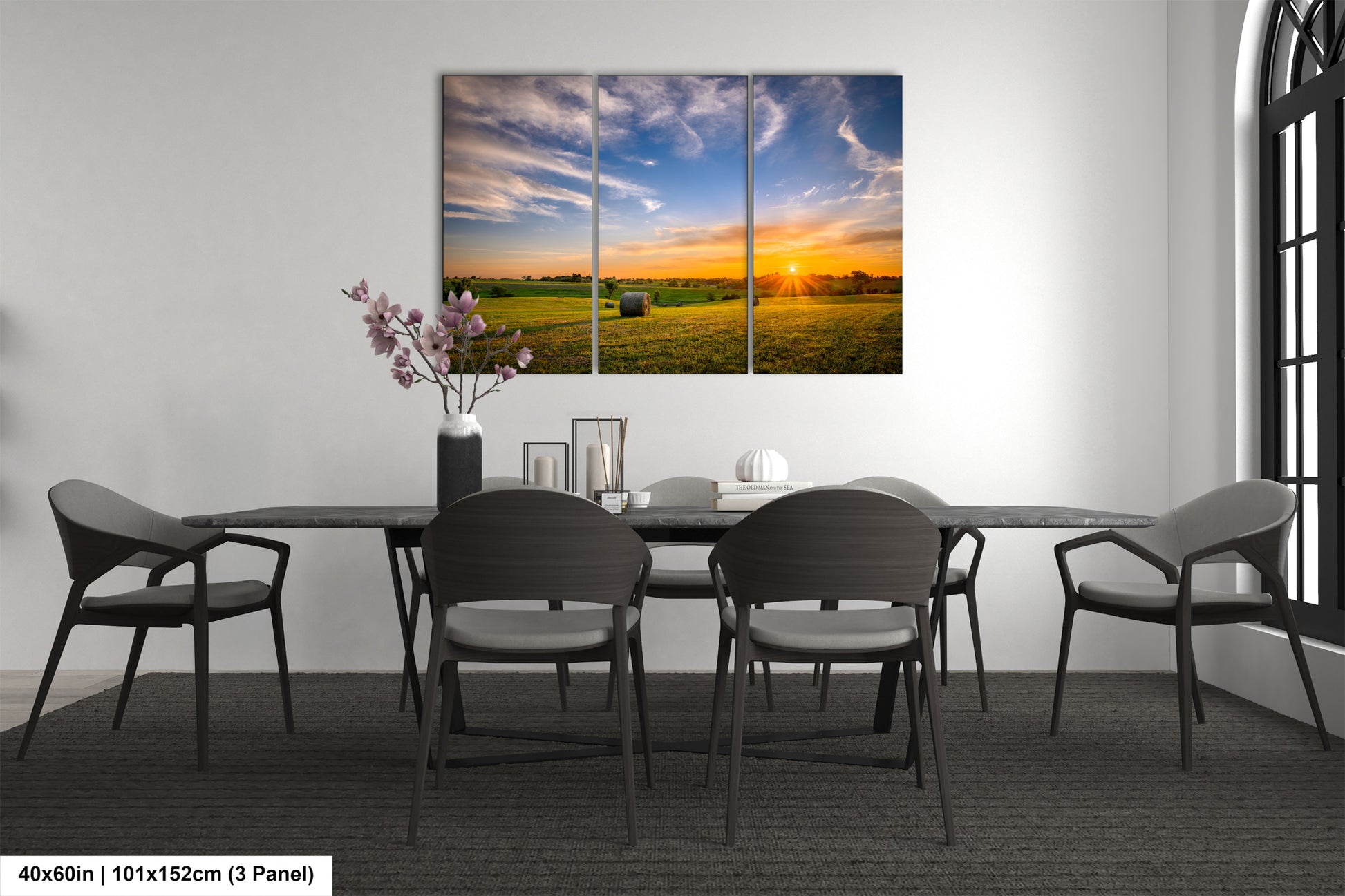 a dining room table with chairs and a painting on the wall